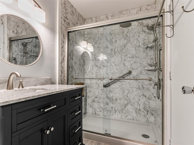 bathroom featuring vanity and a shower with shower door