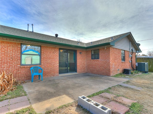 back of property with cooling unit and a patio