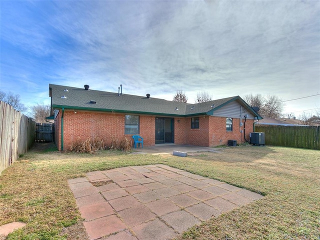 rear view of house with a patio, a yard, and cooling unit