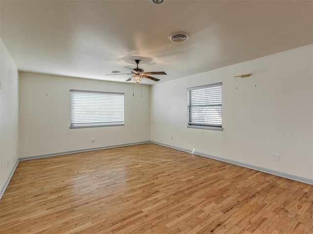 unfurnished room with ceiling fan and light wood-type flooring