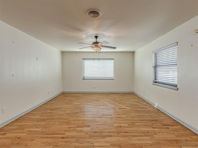 empty room with ceiling fan and light wood-type flooring