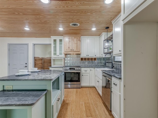 kitchen with white cabinetry, appliances with stainless steel finishes, dark stone countertops, and wood ceiling