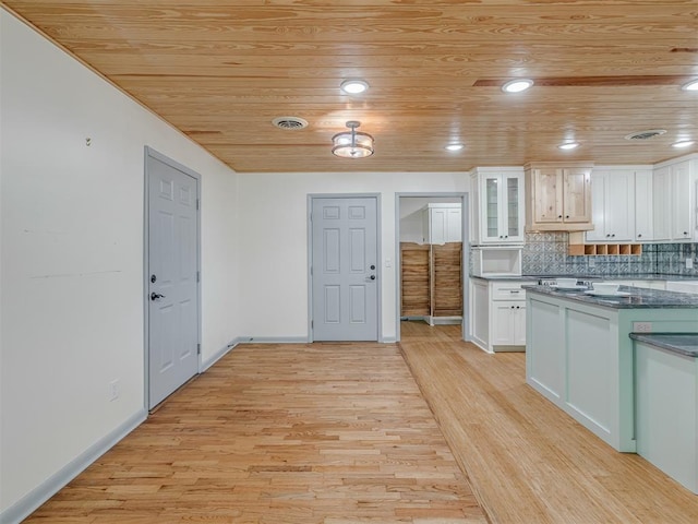 kitchen with white cabinetry, wood ceiling, and light hardwood / wood-style flooring