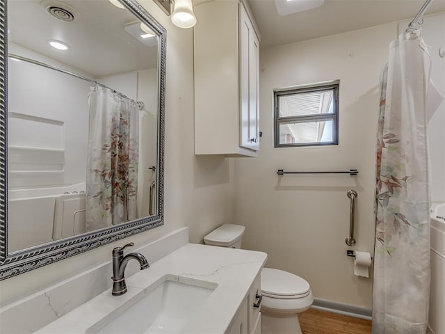 bathroom with vanity, hardwood / wood-style floors, and toilet