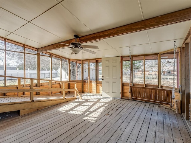 unfurnished sunroom with ceiling fan and beam ceiling