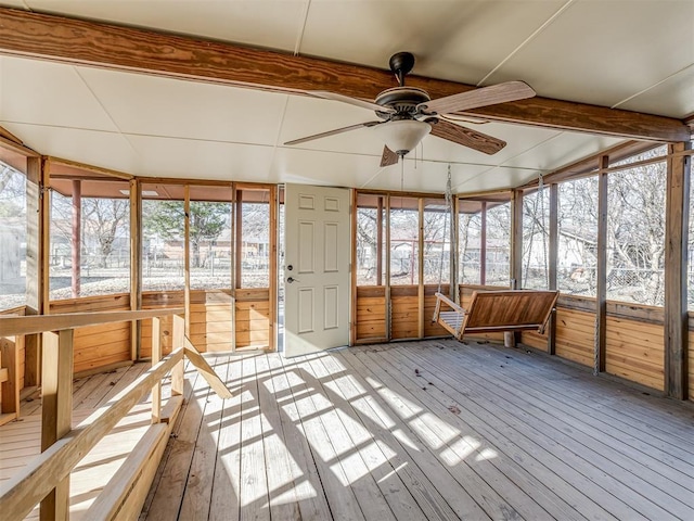 unfurnished sunroom featuring ceiling fan and beam ceiling