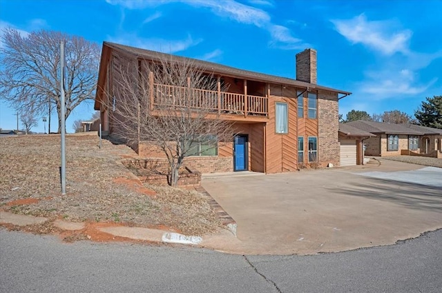 view of front of house with a garage and a balcony