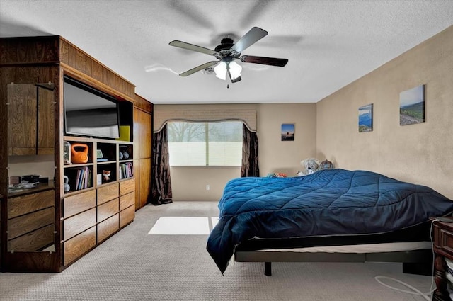 bedroom with light carpet, a textured ceiling, and ceiling fan