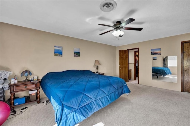 carpeted bedroom with ceiling fan and a spacious closet