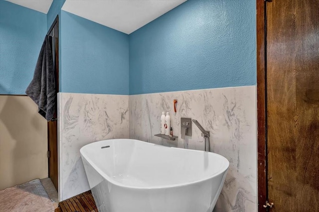 bathroom with tile walls and a washtub