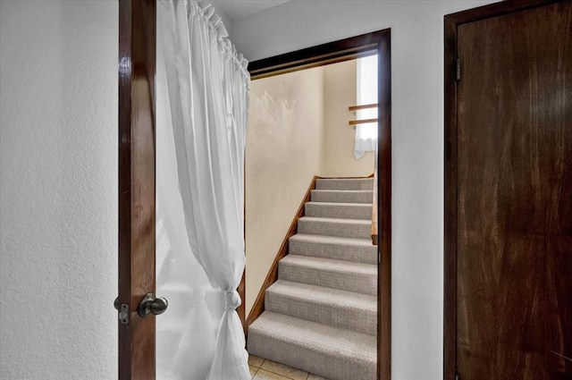 stairs featuring tile patterned flooring