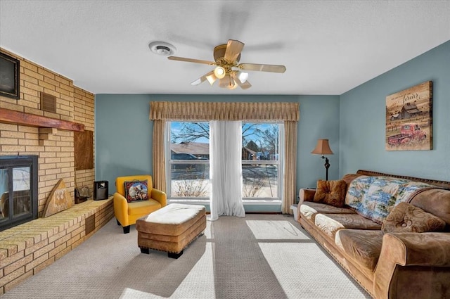 living room with a brick fireplace, light colored carpet, and ceiling fan