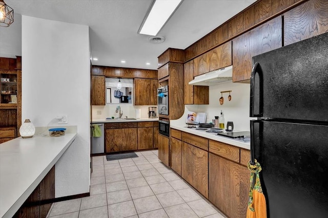 kitchen with stainless steel appliances, light tile patterned flooring, and sink