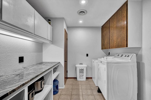 laundry room with cabinets, separate washer and dryer, and light tile patterned floors