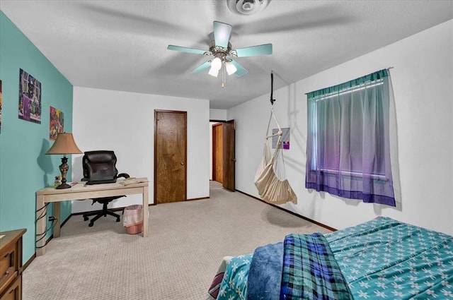 bedroom with a textured ceiling, ceiling fan, and carpet