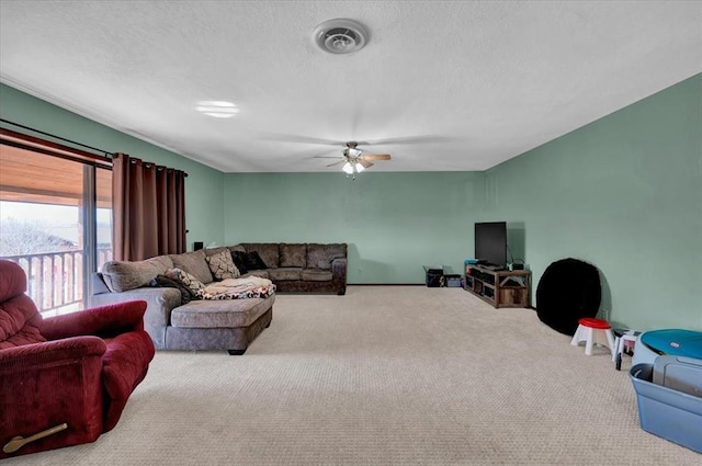 carpeted living room featuring ceiling fan