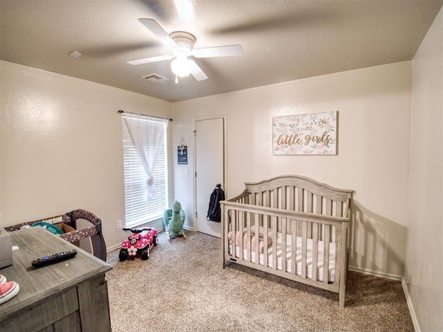 carpeted bedroom with ceiling fan, visible vents, and baseboards