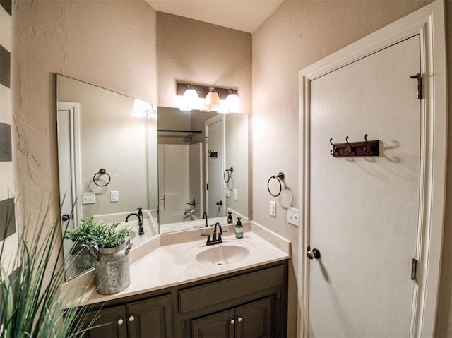 bathroom featuring shower / tub combination and vanity