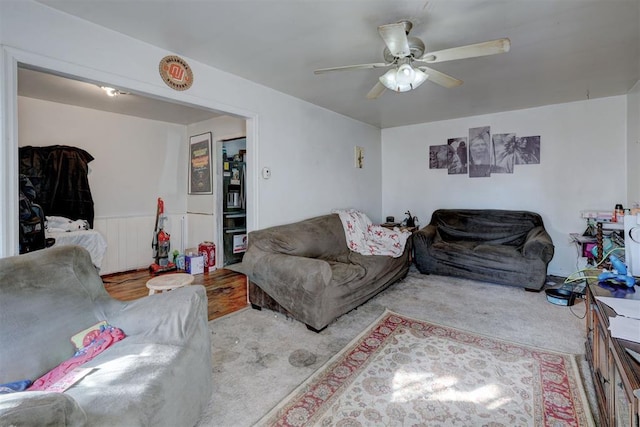 carpeted living room with ceiling fan