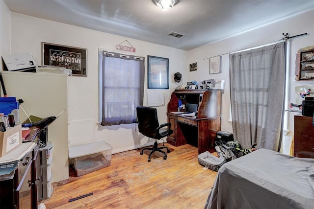 office space with wood-type flooring