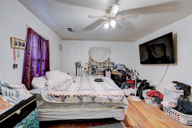 bedroom featuring hardwood / wood-style flooring and ceiling fan