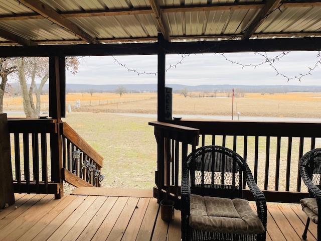 wooden deck featuring a rural view