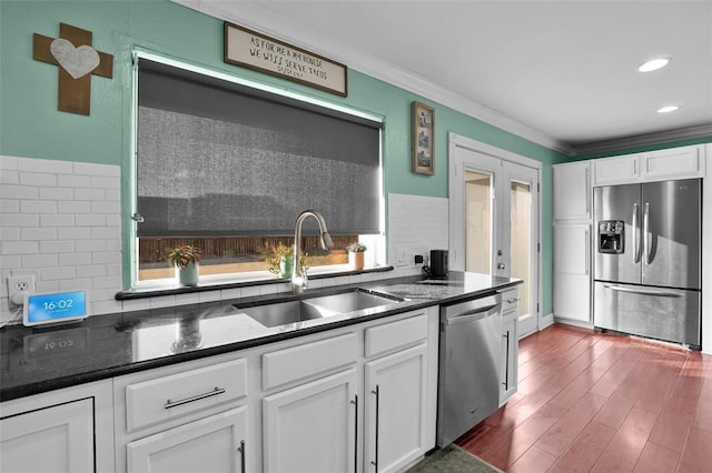 kitchen featuring sink, white cabinets, stainless steel appliances, crown molding, and french doors