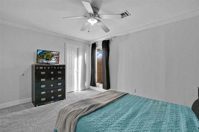 carpeted bedroom featuring ornamental molding and ceiling fan