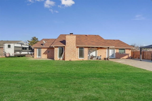 back of house with a lawn