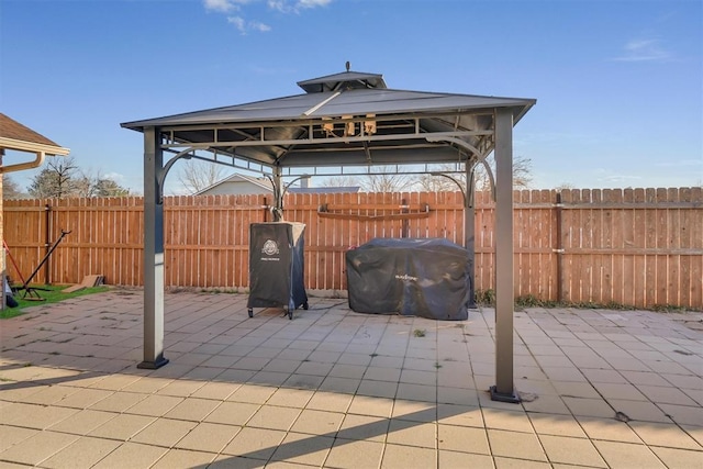 view of patio with area for grilling and a gazebo