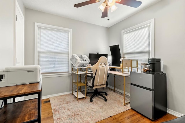 office area featuring light hardwood / wood-style floors and ceiling fan