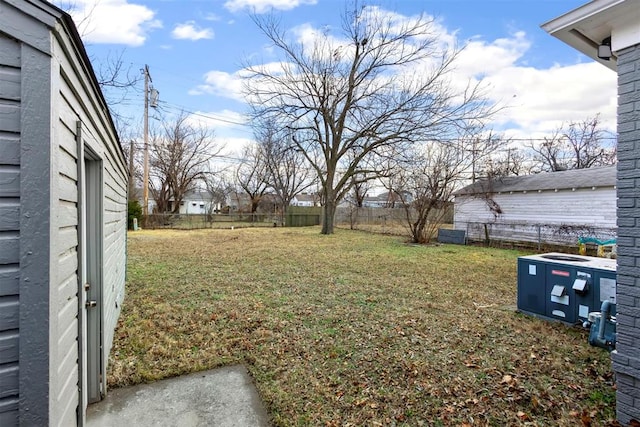 view of yard with a fenced backyard and central air condition unit