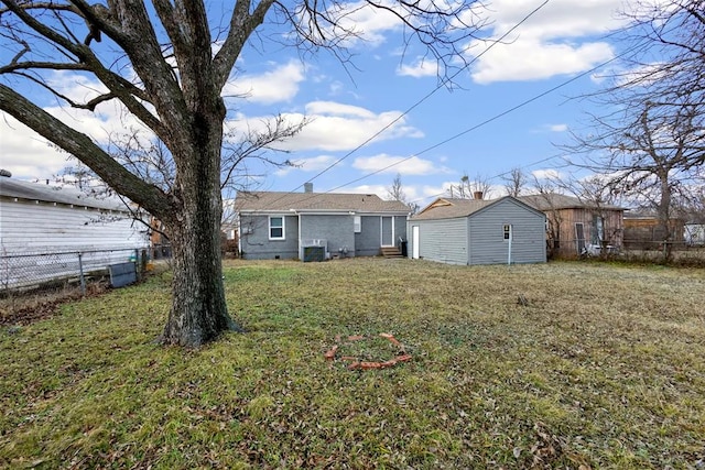 back of house with crawl space, a lawn, and fence