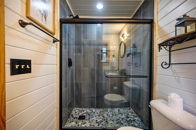 bathroom featuring an enclosed shower and toilet