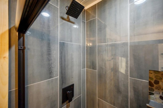 interior details featuring tiled shower