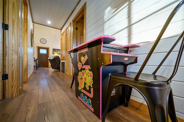 interior space featuring wood-type flooring and wood walls