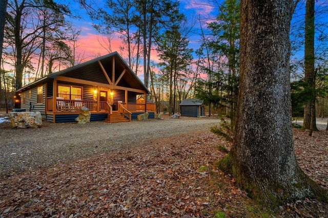 exterior space featuring a porch and a storage unit