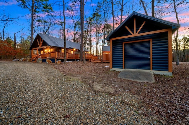 view of garage at dusk