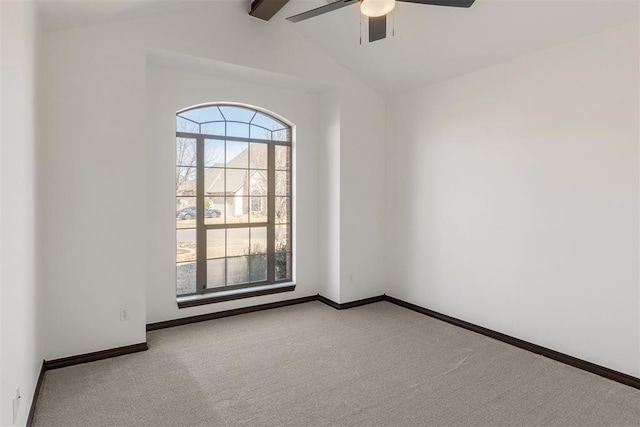 spare room featuring ceiling fan, lofted ceiling with beams, and light carpet