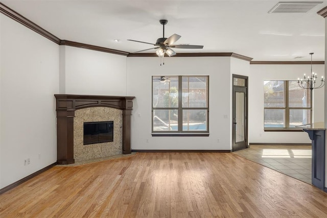 unfurnished living room with light hardwood / wood-style flooring, plenty of natural light, and a tile fireplace