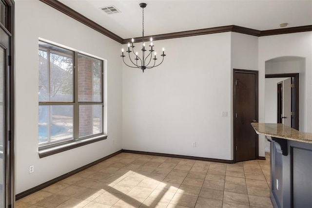 unfurnished dining area with crown molding and an inviting chandelier