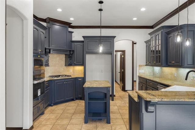 kitchen featuring sink, decorative light fixtures, ornamental molding, appliances with stainless steel finishes, and a kitchen island