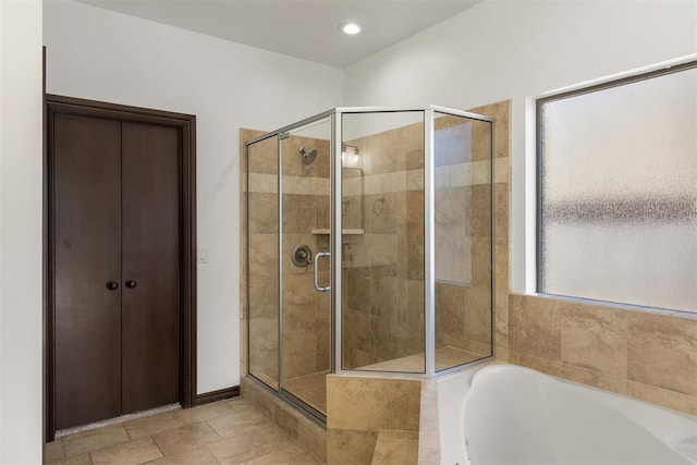 bathroom featuring plus walk in shower and tile patterned floors