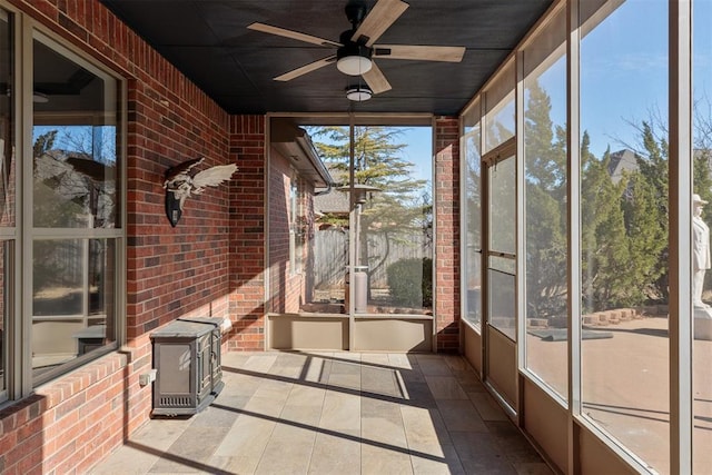unfurnished sunroom with ceiling fan