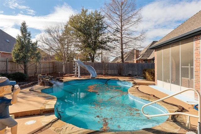 view of pool featuring a patio and a water slide