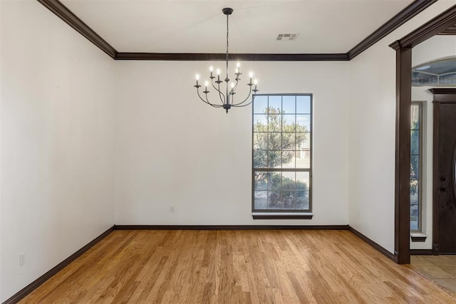unfurnished dining area with crown molding, light hardwood / wood-style flooring, and a chandelier