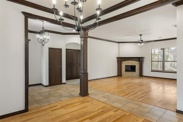 unfurnished living room featuring ceiling fan with notable chandelier, crown molding, light hardwood / wood-style floors, and ornate columns