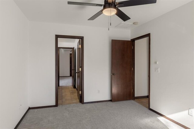 unfurnished bedroom with light colored carpet and ceiling fan