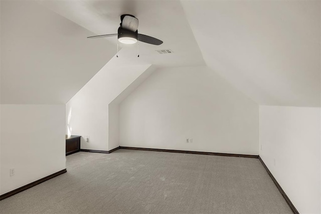 bonus room featuring lofted ceiling, light colored carpet, and ceiling fan