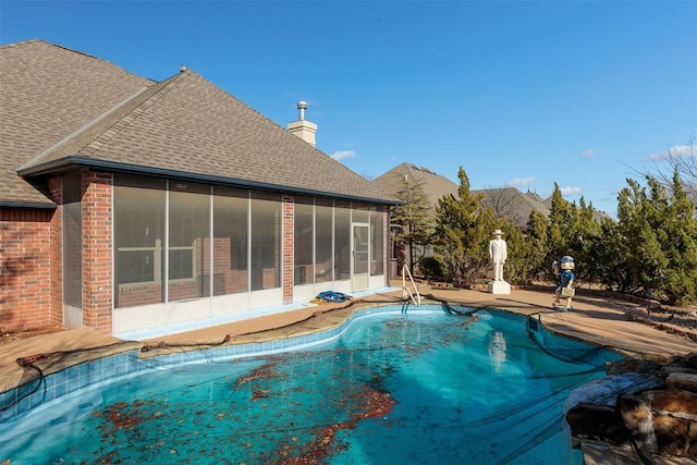view of pool with a sunroom